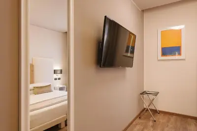 a bedroom with a tv on the wall and a bed at Etruska luxury Trastevere Guesthouse in Rome