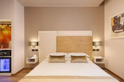 a bedroom with a large white bed with two pillows at Etruska luxury Trastevere Guesthouse in Rome