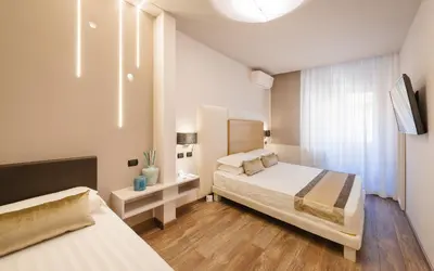 a hotel room with two beds and a tv at Etruska luxury Trastevere Guesthouse in Rome