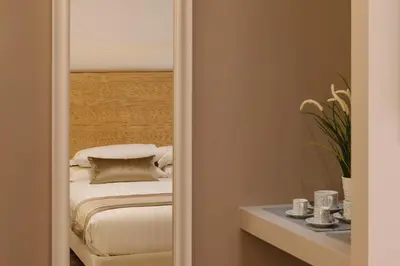 a bedroom with a mirror and a bed at Etruska luxury Trastevere Guesthouse in Rome