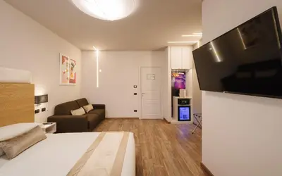 a bedroom with a bed and a flat screen tv at Etruska luxury Trastevere Guesthouse in Rome