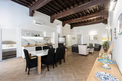 a kitchen and living room with a table and chairs at Rental in Rome - Bramante Luxury in Rome