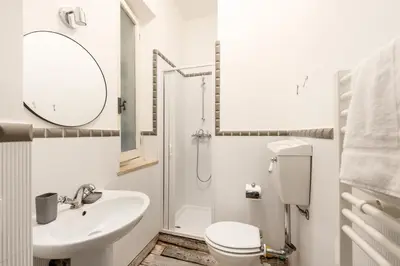 a bathroom with a sink and a toilet and a shower at White flat Rione Monti in Rome