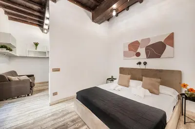 a bedroom with a large bed and a couch at White flat Rione Monti in Rome