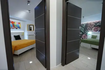 a bedroom with a bed and a sliding door at Duca's House in Rome