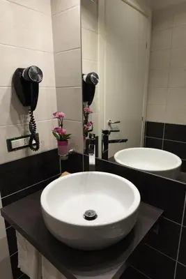 a bathroom with a white sink and a mirror at Duca's House in Rome