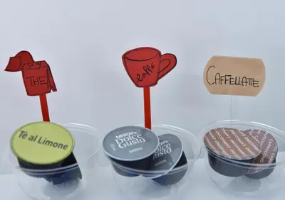a group of five plastic cups with different signs on them at Duca's House in Rome