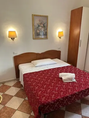 a bedroom with a bed with two towels on it at B&B Sergio House in Rome