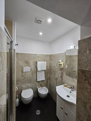 a bathroom with a toilet and a sink at Guest House Galaxy in Rome