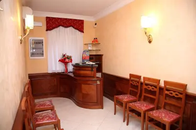 a waiting room with chairs and a desk in a room at Guest House Galaxy in Rome