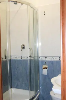 a bathroom with a glass shower with a toilet at Guest House Galaxy in Rome