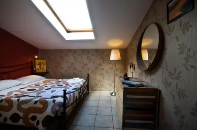 a bedroom with a bed and a mirror at Alma de Roma in Rome