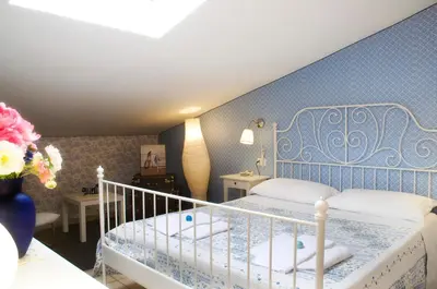 a bedroom with a bed and a blue wall at Alma de Roma in Rome