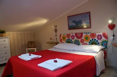 a bedroom with a bed with two towels on it at Alma de Roma in Rome