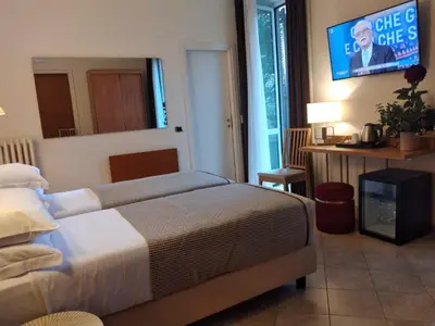 a bedroom with a bed and a tv on the wall at Hotel Principe Eugenio in Rome