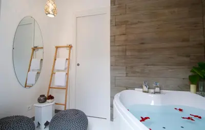 a bath tub in a bathroom with a wooden wall at B&B Amor in Rome