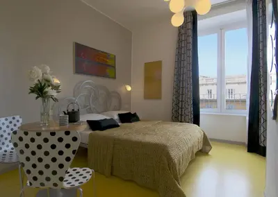 a bedroom with a bed and a table and a window at B&B Amor in Rome