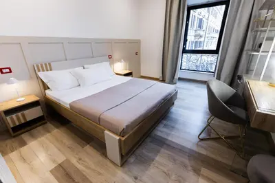 a bedroom with a bed and a desk and a chair at La Vite Vaticana in Rome