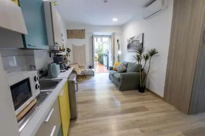 a kitchen and living room with a couch at La Vite Vaticana in Rome