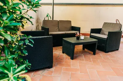 a patio with two chairs and a table and chairs at La Vite Vaticana in Rome