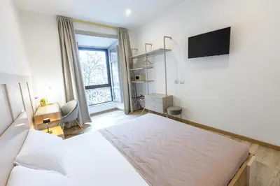 a bedroom with a bed and a tv on a wall at La Vite Vaticana in Rome
