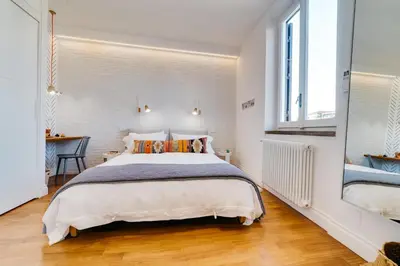 a bedroom with a large bed and a desk at Beautiful designer apartment close to Pantheon in Rome