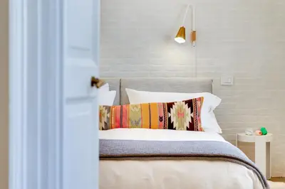 a bedroom with a bed with white sheets and pillows at Beautiful designer apartment close to Pantheon in Rome
