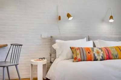 a bedroom with a bed with a chair and a table at Beautiful designer apartment close to Pantheon in Rome