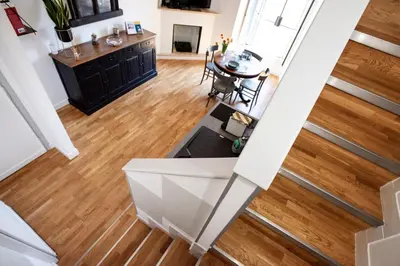 an overhead view of a kitchen and living room with wood floors at Argentina apartment Roof View in Rome