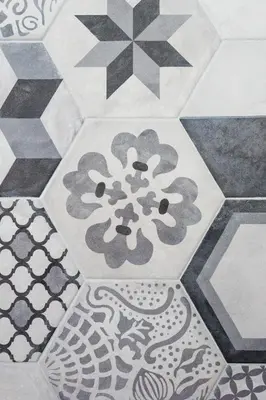 a close up of a tile floor with a flower on it at Argentina apartment Roof View in Rome