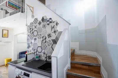 a bathroom with a sink and a staircase at Argentina apartment Roof View in Rome