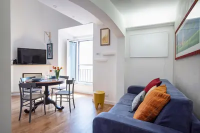 a living room with a blue couch and a table at Argentina apartment Roof View in Rome