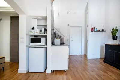 a kitchen with white cabinets and a microwave at Argentina apartment Roof View in Rome