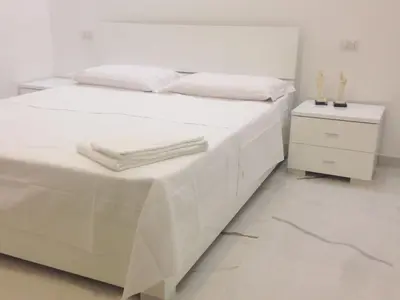 a white bed with white sheets and towels on it at B&B Palombini in Rome
