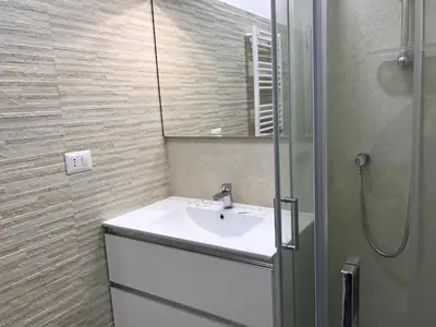 a bathroom with a white sink and a shower at B&B Palombini in Rome