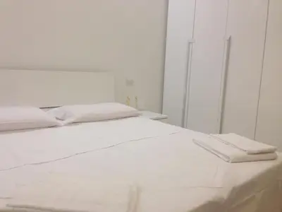 a white bed with two white towels on it at B&B Palombini in Rome