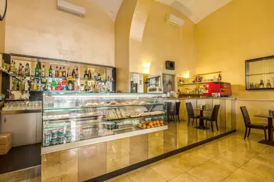 a restaurant with a bar with a display of drinks at Hotel Maryelen in Rome