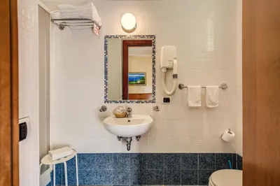 a bathroom with a sink and a toilet at Hotel Maryelen in Rome