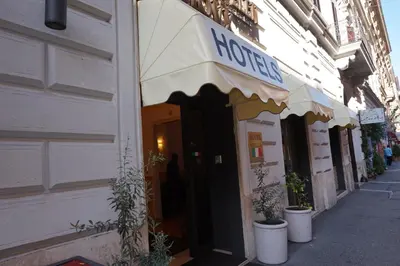 a shop with an awning on the side of a building at Hotel Maryelen in Rome