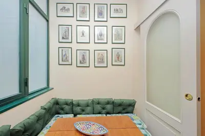 a living room with a green couch and a table at Pantheon Luxury Apartment in Rome