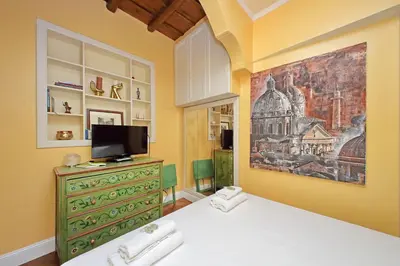 a bedroom with a bed and a painting on the wall at Pantheon Luxury Apartment in Rome