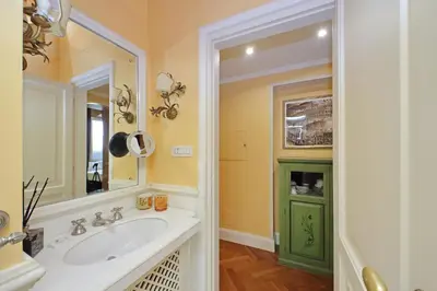 a bathroom with a sink and a mirror at Pantheon Luxury Apartment in Rome