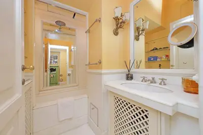 a white bathroom with a sink and a mirror at Pantheon Luxury Apartment in Rome