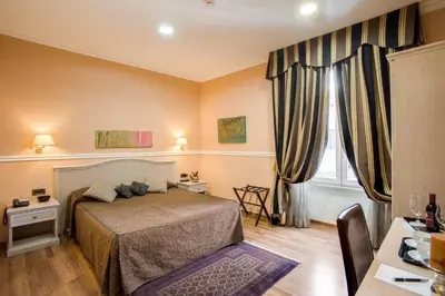 a bedroom with a bed and a window with curtains at PapavistaRelais in Rome