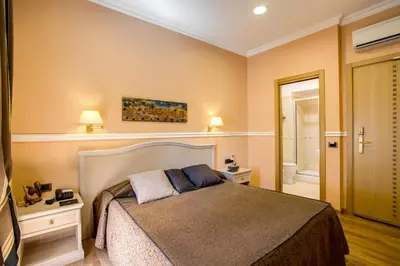 a bedroom with a large bed and a bathroom at PapavistaRelais in Rome