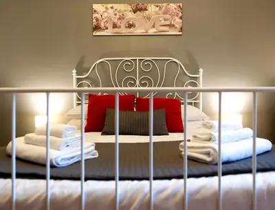 a bed with a metal bed frame with towels on it at Flaminia 36 Luxury Home in Rome