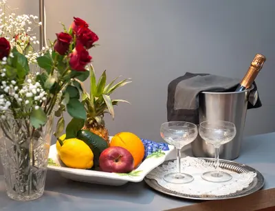 a table with a plate of fruit and two wine glasses at Flaminia 36 Luxury Home in Rome