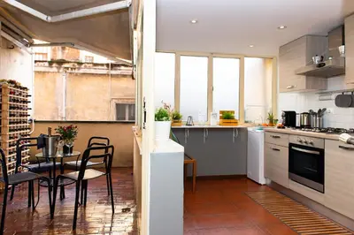 a kitchen with a table and a dining room at Flaminia 36 Luxury Home in Rome