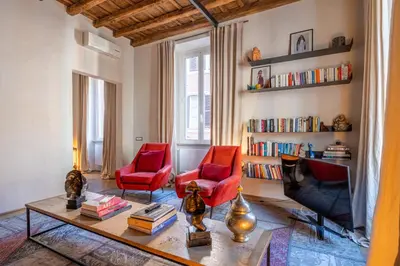 a dining room with a wooden table and chairs at Fontanella Borghese Lux in Rome