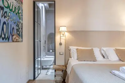 a bedroom with a large bed with two towels on it at Fontanella Borghese Lux in Rome